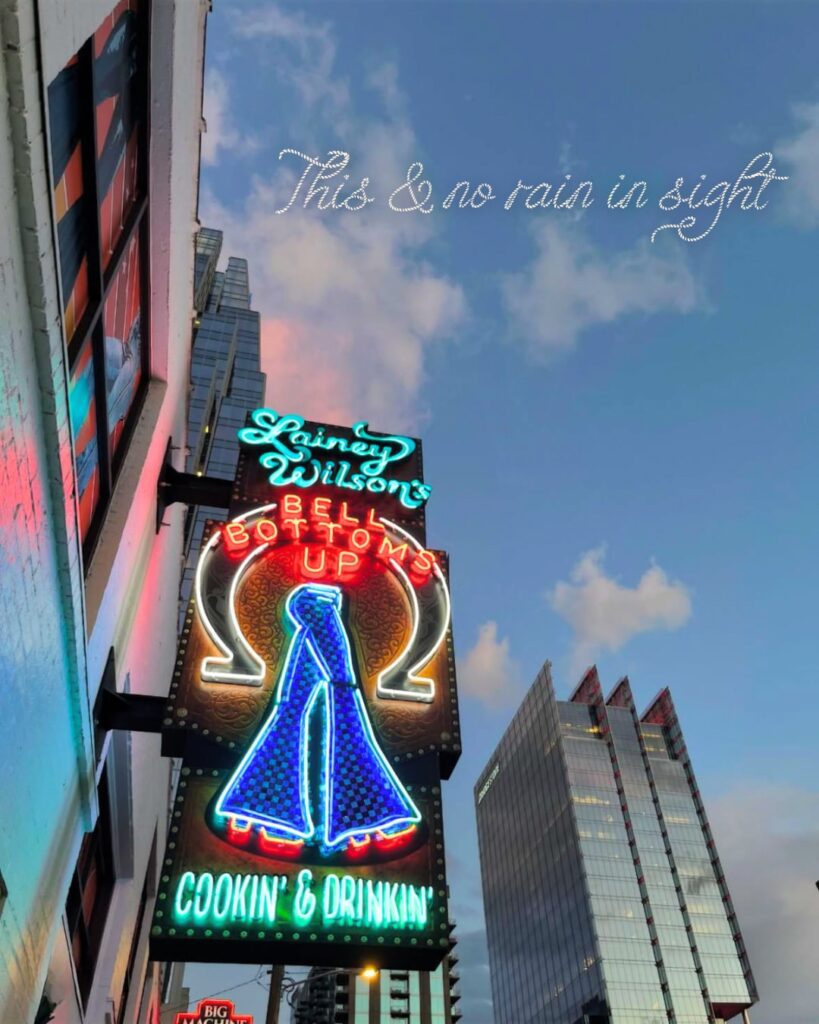 **`Exterior view of Lainey Wilson's Bell Bottoms Up bar in Nashville with vibrant signage and lively street atmosphere.`**