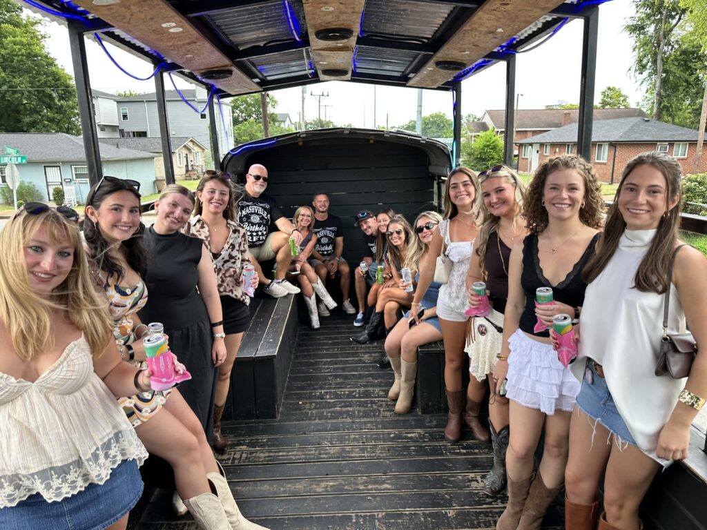 Big group celebrating on a Rowdy Bus private party bus in Nashville