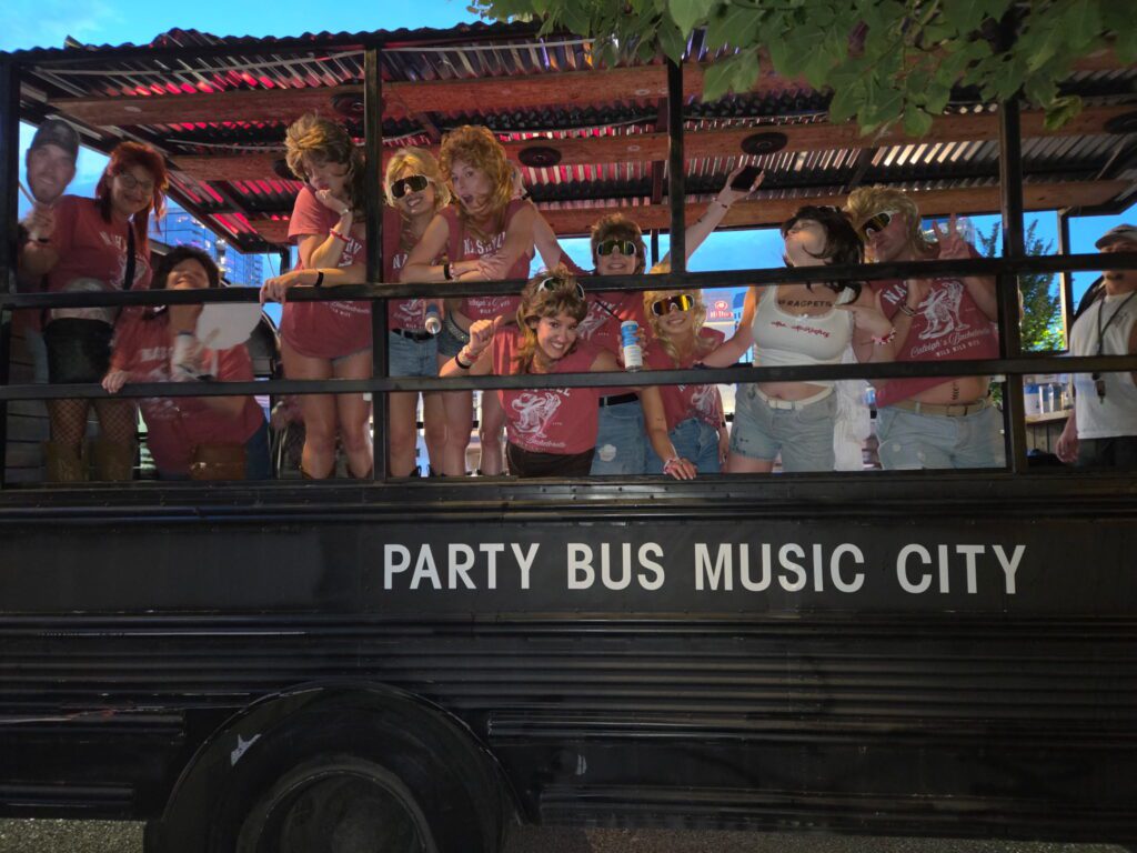 Group in matching red shirts on a Rowdy Bus daytime tour in Music City